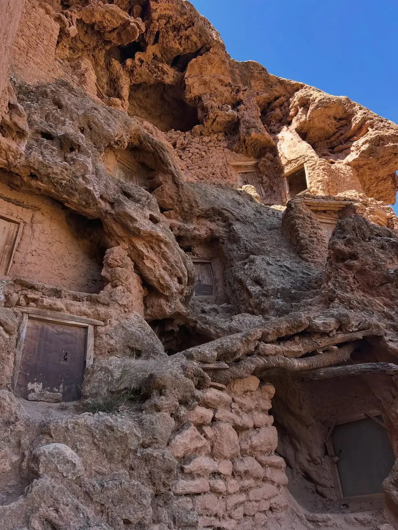 Historic dwellings built into a rocky cliff face in southern Morocco