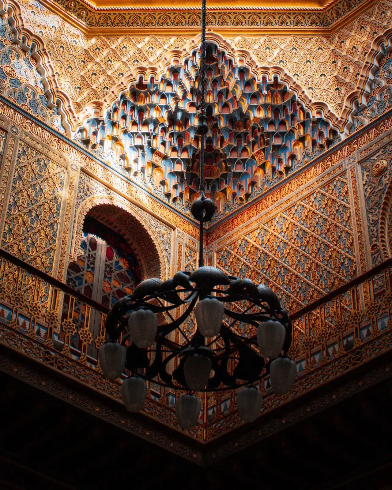 Intricately carved muqarnas cedar ceiling of a Moroccan palace