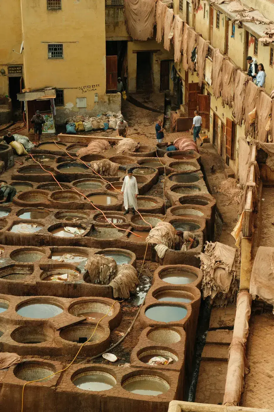 Stone vats filled with natural dyes at the Chouara Tannery in the Fes medina, Morocco