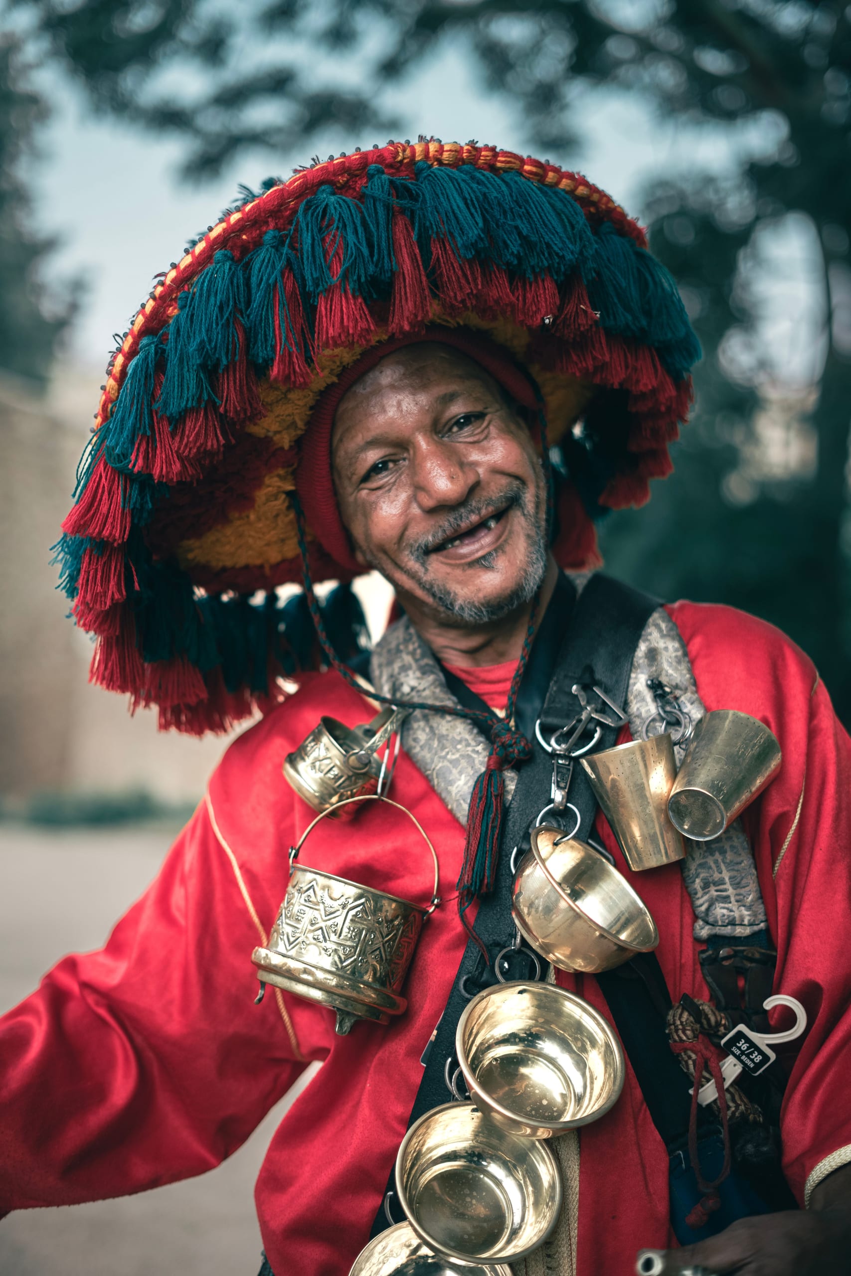 Close-up portrait of a smiling Guerrab water seller in ceremonial costume
