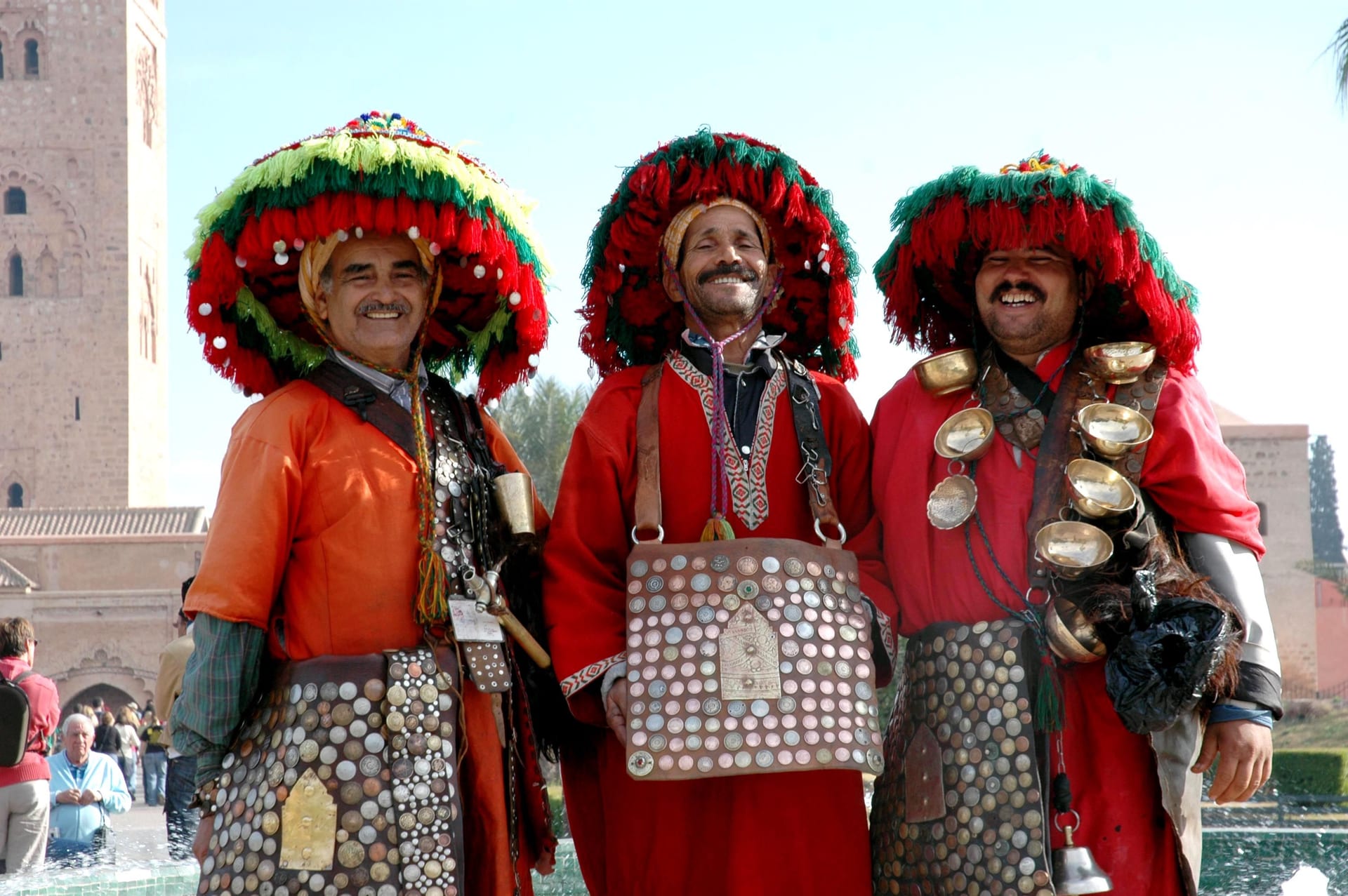 Three traditional Moroccan Guerrab water sellers near Koutoubia Mosque
