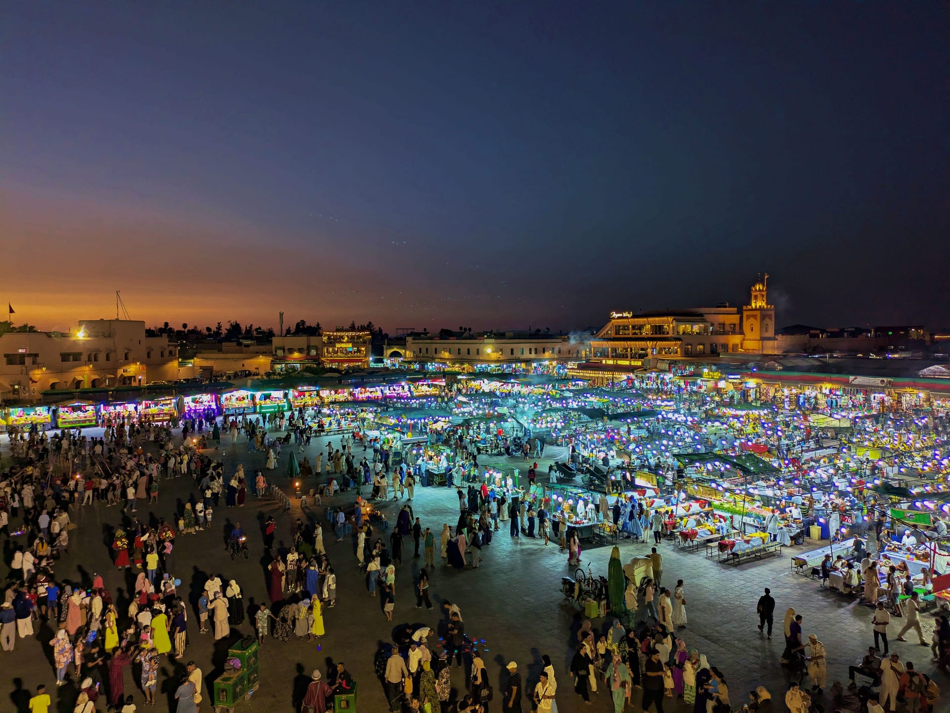 Aerial night view of Jemaa el-Fna packed with illuminated food stalls in Marrakech