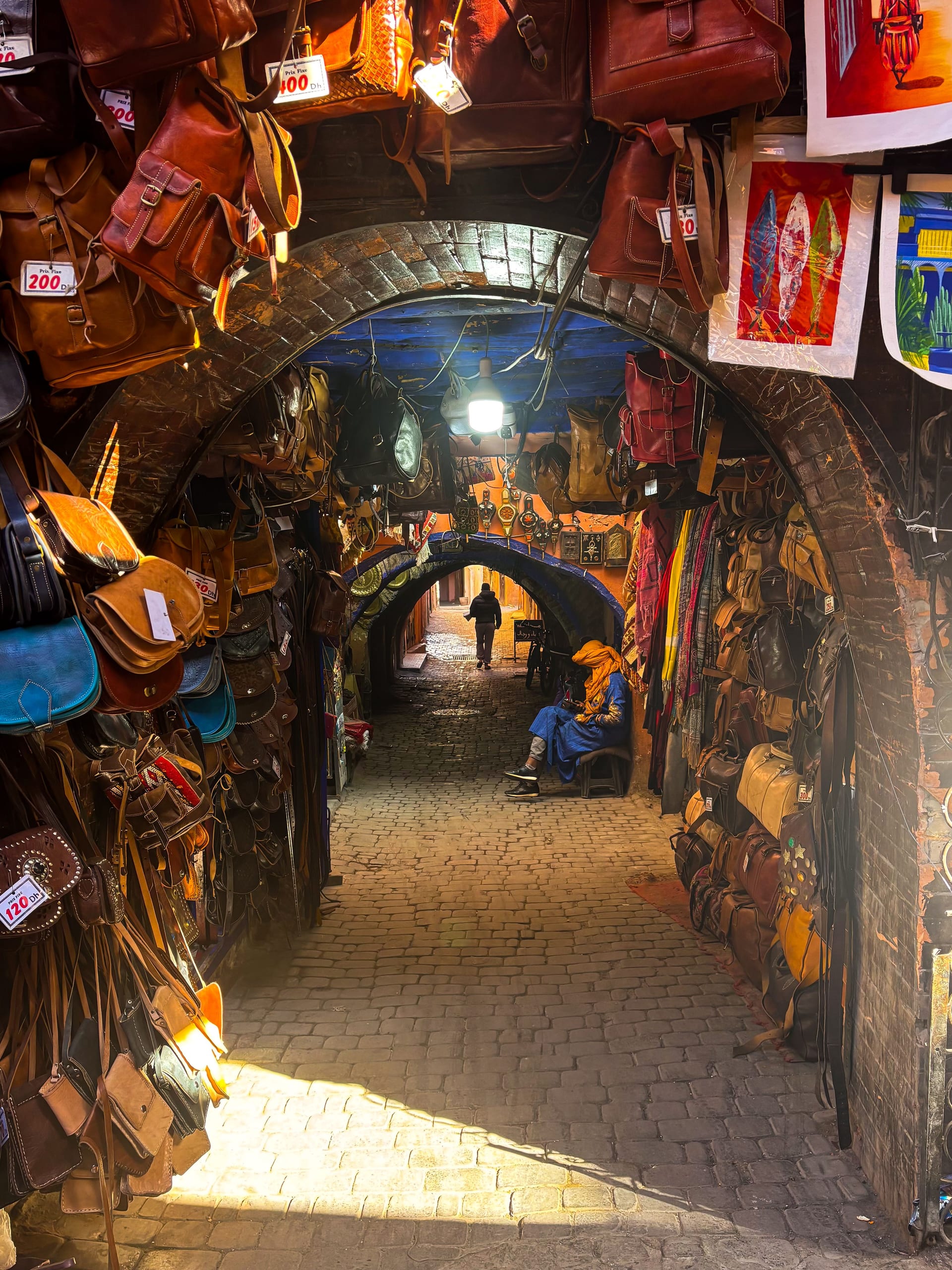 Atmospheric leather souk tunnel crammed with hanging bags in the Marrakech medina