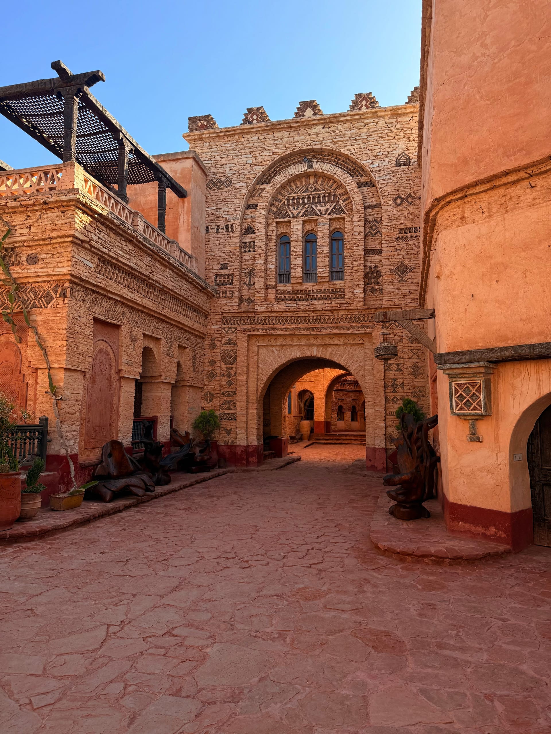 Ornate Moroccan riad courtyard with carved stone facades in southern Morocco