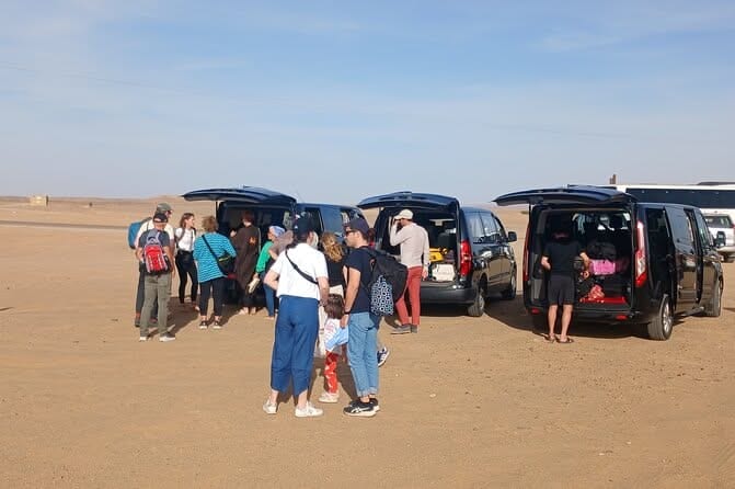Group loading into three private black minivans — Morocco Grand Adventure fleet