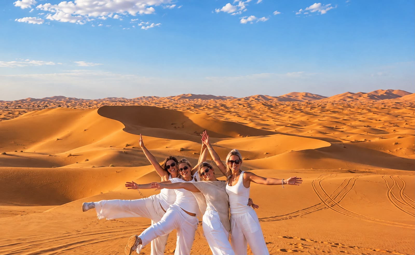 Students walking across a large dune field at Erg Chebbi